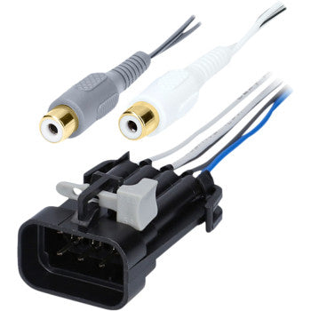 The image shows a black automotive connector with a gray clip next to the Polaris Audio Adapter Ride Command by Saddle Tramp, featuring two RCA female connectors (gray and white), each with attached wires.