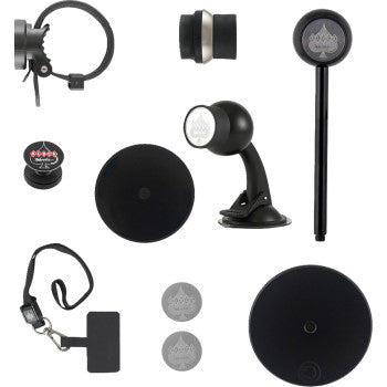 The iOmounts® Essentials Collection 1 by Klock Werks features black circular magnetic phone mounts, stands, wrist straps, and adhesive discs—some with an Ace of Spades logo—perfectly arranged on a white background for sleek device organization.