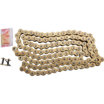 The 420 MXZ Heavy Duty Drive Chain 124 Links by Rk, gold-colored with seamless rollers, is coiled loosely on a white background, shown alongside a small lubricant packet and a master link.