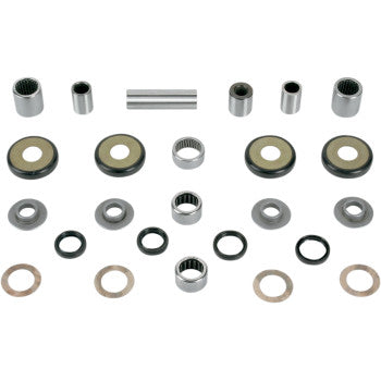 Set of metal swingarm linkage bearings, bushings, seals, and washers arranged on white background.