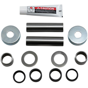 The Swingarm Bearing Kit by Pivot Works includes assorted metal bushings, sleeves, and washers arranged with a lubricant tube on a white background—ideal for your next linkage kit built to OEM specs.