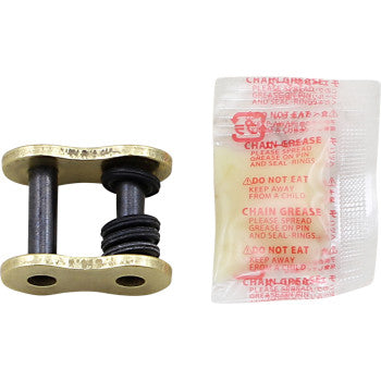 The 525 Max Z Connecting Link Rivet Gold by Rk, a metal motorcycle chain link with two rubber O-rings, is displayed beside a small packet of chain grease marked with red warning text.
