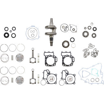 Complete engine rebuild kit with metal crankshaft, pistons, gaskets, seals, bearings, and circlips arranged on white.