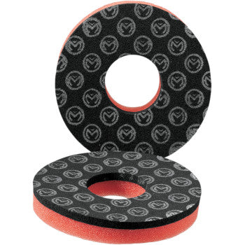 Two round Dual Layer Grip Donuts by Moose Offroad, black and red with center holes, stacked at an angle. They offer full coverage with a black surface featuring a repeating white Moose Offroad logo pattern.