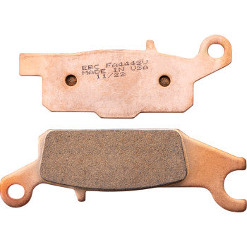 Two copper-colored SV Severe Duty Brake Pads by Ebc are shown: one exposes the friction material, while the other displays the flat metal backing engraved with manufacturing details, designed for ultra-long pad life.