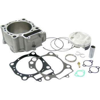 Silver metal cylinder with piston, piston rings, various black and green gaskets, small metal clips, and a cylindrical pin.