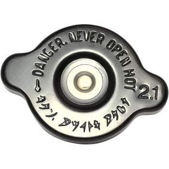 Close-up of the K&S Technologies High Pressure Radiator Cap Black Seal 30 PSI, featuring “DANGER. NEVER OPEN HOT 2.1” and symbols, engineered for reliable cooling system performance.
