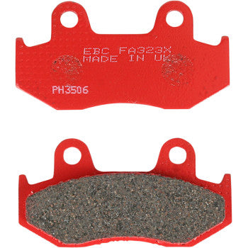 Red metal sport carbon brake pads with textured friction surface and mounting holes.