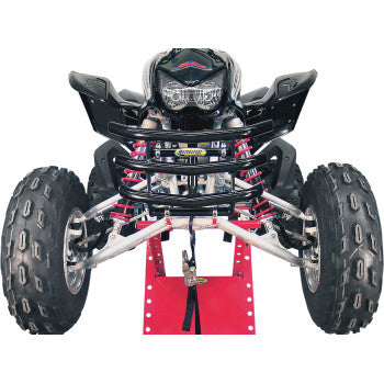 Front view of an ATV with large off-road tires, visible suspension springs, and black bodywork fitted with the EZ Fit Bumper Sport Black by Motorsport Products, positioned on a red maintenance stand.