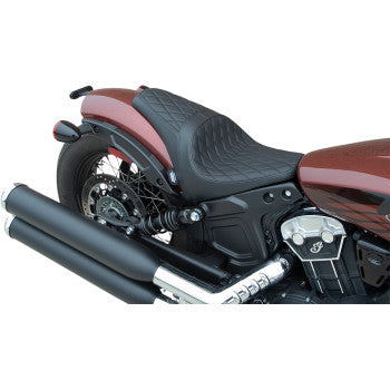 A close-up side view of the Drag Specialties 3/4 Solo Seat in black diamond stitch on a maroon motorcycle, highlighting the rear wheel, dual exhaust pipes, and part of the engine.