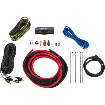The Amplifier Installation Kit by Kicker is displayed on a white background with a MANL fuse holder, oxygen-free copper red and black power cables, RCA and braided cables, wire ties, connectors, and blue speaker wire.