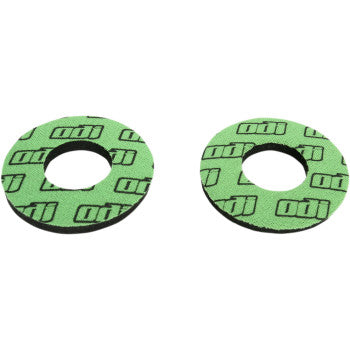 Bright green circular foam grips with black Odi logo pattern, designed for offroad handlebar use.