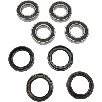 The KingQuad Wheel Bearing Kit Front Eiger Vinson by Pivot Works features eight circular parts—four sealed ball bearings and four black rubber seals—arranged in two rows, ideal for improving wheel bearings or steering control.