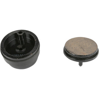 Round sintered brake pads with black backing and tan friction surface, designed for Yamaha Blaster 200.