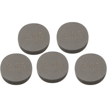 Set of five round gray metal valve shims with "2.35" engraved on each surface.