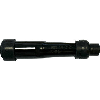 A black cylindrical Spark Plug Cap Straight 14 mm by K&S Technologies, with ridged ends, smooth center, and rubber caps. The side is printed with K&S 10-2121 5-KΩ, giving it a resistor-like appearance.