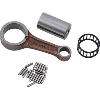 The Yamaha Connecting Rod Kit by Hot Rods, crafted from AISI 8620 steel, includes a cylindrical roller bearing, pin, and multiple loose needle bearings—arranged on a white background for high-RPM bearing performance.