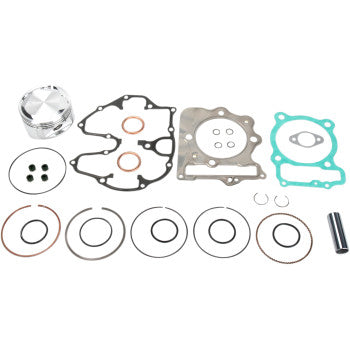 The Honda Piston Kit with Gaskets 86.00 mm by Wiseco includes a piston, rings, gaskets, seals, and small metal parts—all neatly arranged on a white background.