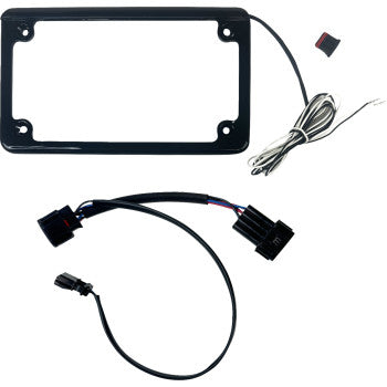 The Polaris RZR Turn Signal Kit Front & Rear Black by Custom Dynamics includes a black rectangular license plate frame with an attached wire, small button switch, LED illumination, and separate electrical connectors with black cables.