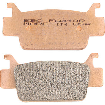 Pair of copper-colored sintered brake pads with textured friction surface and engraved text.