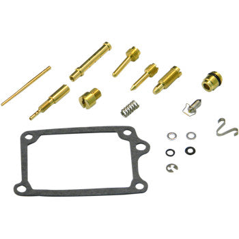 The Suzuki Carburetor Repair Kit by Shindy includes brass jet needles, float valves, a spring, washers, O-rings, clips, and a rectangular gasket—all arranged neatly on a white background.