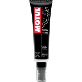 A 150ml black tube of Motul Chain Paste with a red and white label, showing a chain diagram and brush applicator. Designed for road bikes, this paste reduces friction for smoother rides.