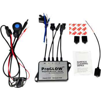 A Controller Bluetooth by Custom Dynamics kit with app-controlled, color-changing lights—includes control box, wired remote, connectors, adhesive pads, fuse, wipes, and accessories—neatly arranged on a white background.