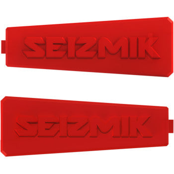 The Color Inserts - Strike Mirror Red Pair by Seizmik are two red rectangular rubber pieces with SEIZMIK embossed, angled edges on one side, and small tabs on the other, designed to match popular vehicle colors.