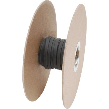 A spool with large circular cardboard ends holds a tightly wound coil of DEI Heat Shrink Tube, 1/4 x 50, in black, suitable for electrical insulation.