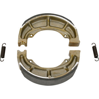 Two radius-ground Ebc Brake Shoes with grooved surfaces are shown side by side, each paired with original-style brake shoe springs for a precise fit and reliable performance.