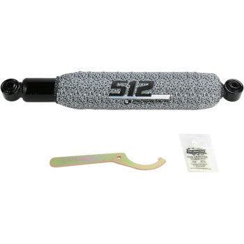 The 512 Series Rear Shocks by Progressive Suspension, in gray and black with progressive rate springs, are shown with a small wrench and lubricant packet on a white background.