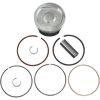 Silver metal piston with a flat top, black base, assorted black and bronze piston rings, a silver wrist pin, and small.