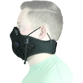 Side view of a person wearing the Neoprene Dust Mask (Black) by ATV-TEK with one-way exhaust valves and adjustable ear straps for dust protection. The person in a light green shirt is set against a white background.