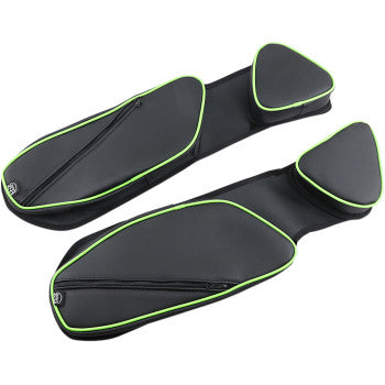 Two black Door Bag Green by Bs Sand motorcycle seats with green piping are displayed side by side on a white background. Each features a triangular padded end and a zippered storage area for small essentials.
