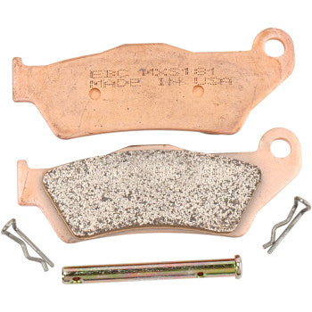 Two MXS Brake Pads (Front) by Ebc displayed: one shows the high-performance sintered bronze surface, the other reveals its stamped label. Package also includes a pin and two metal clips.