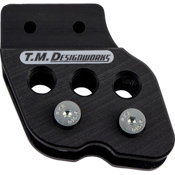 The Honda - Yamaha - Kawasaki - Suzuki Chain Guide Black by T.M. Designworks features UV protection, three circular holes, and two silver screws, displayed against a white background.