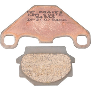 Two Standard Brake Pads by Dp Brakes: one with an engraved product code, the other showing the friction material. Both feature attachment holes and deliver fade-free braking performance.