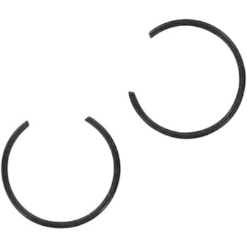 Two black, circular Circlip by Wiseco components with open ends are positioned diagonally on a white background, ideal for securing high-silicon alloy pistons in demanding, high-strength applications.
