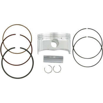 Silver cylindrical metal piston with grooves, two sets of black and bronze piston rings, a silver wrist pin, and two small.