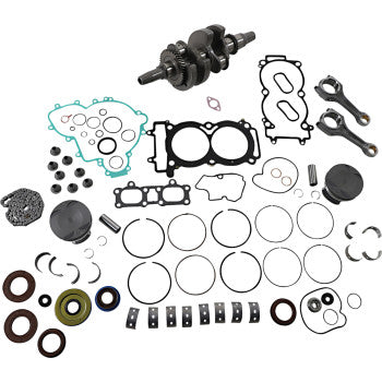 Polaris engine rebuild kit with crankshaft, gaskets, piston rings, seals, bearings, and connecting rods arranged on white.