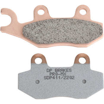 Front and back views of Pro MX Sintered Brake Pads by Dp Brakes highlight the textured friction material and a smooth side labeled DP BRAKES PRO-MX SDP411/2202, designed for peak braking performance.