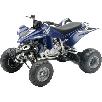 The Yamaha YFZ 450 1:12 Scale by New Ray Toys, shown in black and blue with rugged tires, exposed suspension, a black seat, and detailed accents, is displayed from a front-side angle on a white background.