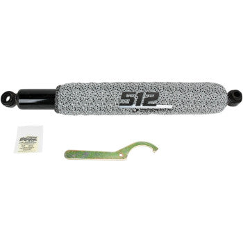 Black metal rear shock with grey protective cover labeled 512, includes mounting hardware and green adjustment spanner.