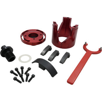 Red anodized aluminum clutch housing, round clutch plate, black clutch shoes, red clutch alignment tool, black bolts, and.