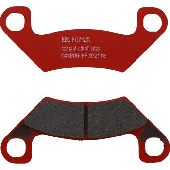 Red metal-backed sport carbon brake pads with black friction surface and dual mounting holes.