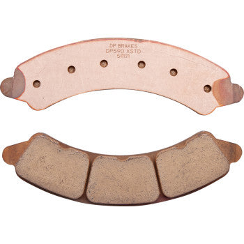 Two Polaris Sintered Brake Pads by DP Brakes are shown—one with a smooth, copper-colored sintered metal surface with holes, the other featuring a textured, three-segment friction surface.