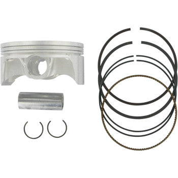 Silver metal piston with wrist pin, two circlips, and multiple black piston rings arranged in a semi-circle.