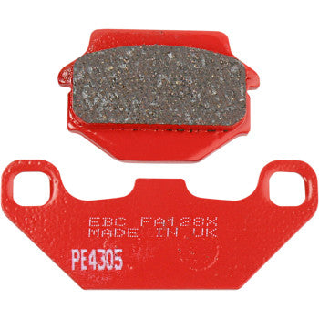 Red sport brake pads with textured gray friction material, labeled EBC FA128X, made in the UK.