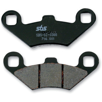 Two Polaris Brake Pads by Sbs are shown—one reveals product markings on the back, the other displays three friction material segments. Both feature two mounting holes per side for a secure fit and minimal rotor wear.