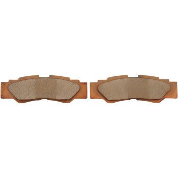 Two Yamaha YXZ Standard Brake Pads by DP Brakes, crafted from brown sintered metal with textured friction surfaces, are shown side by side on a white background—perfect for high-performance braking needs.